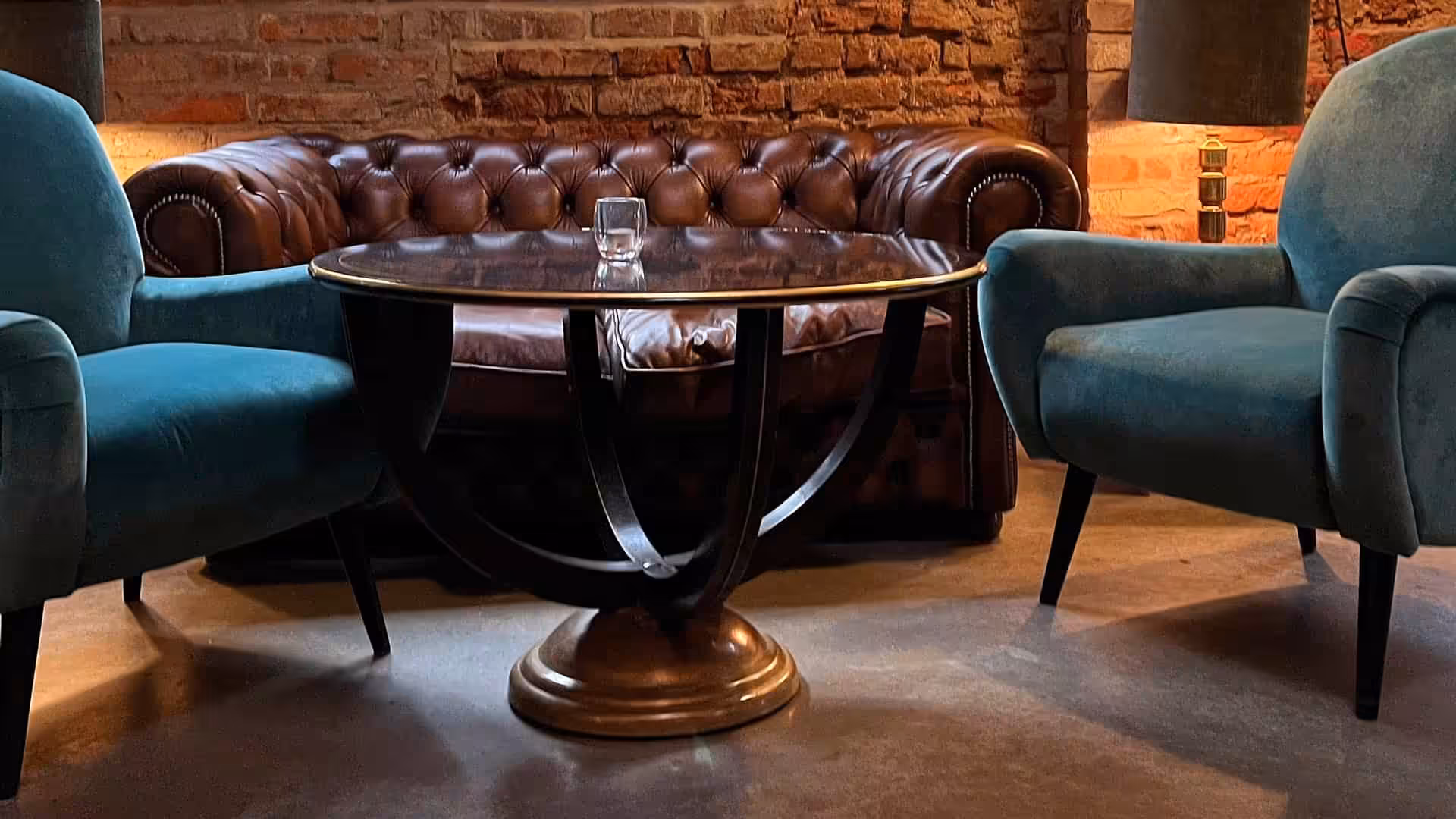 Armchairs, leather couch and a round table, modern setting